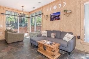 a living room with a couch and a table at Cozy Bear Cabin in Arnold