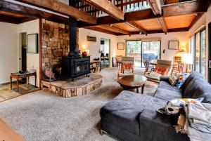 a living room with a couch and a fireplace at Dancing With Trees in Arnold
