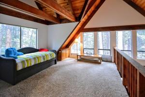 a bedroom with a bed in a room with windows at Dancing With Trees in Arnold +54 photos
