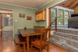 a dining room with a wooden table and stairs at The Bears Bungalow in Arnold