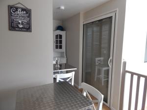 a dining room with a black table and white chairs at Chambre d'Hôtes le massanous in Laure-Minervois