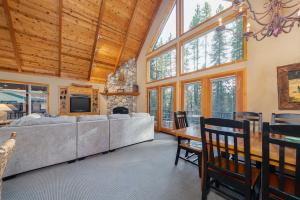 a living room with a large bed and a table and chairs at Big Timber Lodge in Arnold