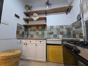 a kitchen with white cabinets and a stove at Simple sea view apartment - families only in Alexandria