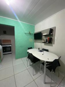 a kitchen with a table and chairs in a room at Flat imobiliado feitosa in Maceió