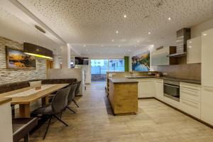 a kitchen with a table and some chairs in it at Apartmenthaus Goldeck in Ried im Oberinntal