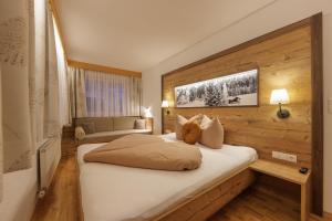 Un pat sau paturi într-o cameră la Apartmenthaus Goldeck