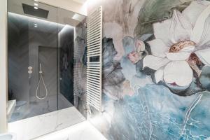 a bathroom with a large painting on the wall at Maison Ginori Guelfa in Florence