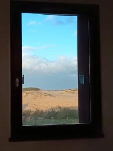 a window in a room with a view of a field at Appartement T2, proche de la mer in Seignosse