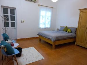 a bedroom with a bed and a table and chairs at Đất Cảng Homestay in Hai Phong