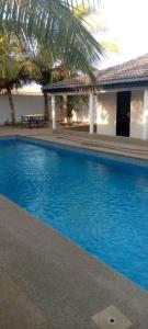 a large blue swimming pool next to a building at Schöne Villa in Nianing, Mbour, Senegal in Nianing