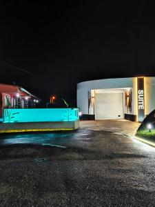 a building with a garage at night at Motel Caldas in Caldas de Reis