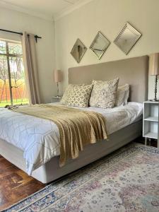 a bedroom with a large bed and a window at Lielies Guesthouse in Parys