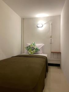 1 dormitorio con 1 cama con 2 almohadas en ReVive by Snooze, en Banyuwangi