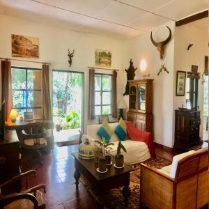 a living room with a couch and a table at Captain's Bungalow, Kandy in Arawwawala