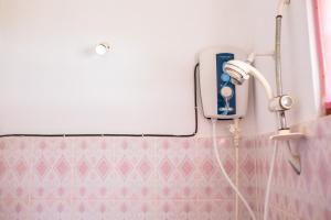 a hair dryer on a wall in a bathroom at Summer Lanka Surf House in Hikkaduwa +84 photos