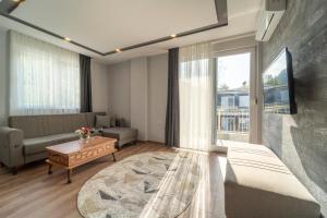 een woonkamer met een bank en een tafel bij Göynük Panorama Luxury Otel in Kemer