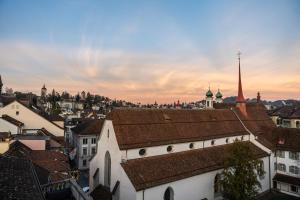 a view of a city with buildings and a church at Hotel Goldener Stern - contactless check-in in Luzern