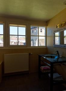 a bathroom with a sink and three windows at Le Château du Fort Villiers-Saint-Benoît in Villiers-Saint-Benoît