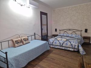 een slaapkamer met twee bedden in een kamer bij L' Arco Rosa in Alatri