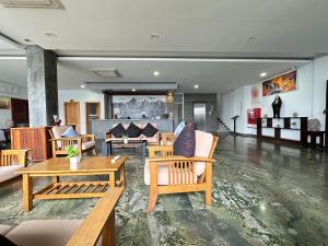 a lobby with chairs and tables in a building at WATBO BRIDGE Residence in Siem Reap