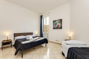 a bedroom with two beds and a window at Magenta Tiburtino in Rome +20 photos