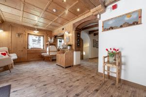 a living room with wooden walls and wooden floors at Villa Adria B&B in Canazei