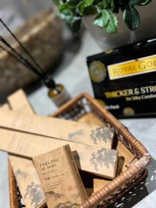 a wicker basket filled with books on a table at The Ash Ipoh - Family Suite in Ipoh +10 photos