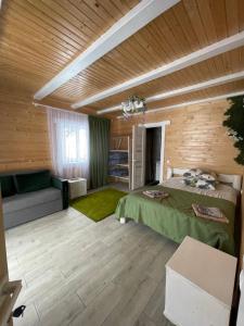a room with a bed and a couch in it at Dva Braty eco in Podobovets