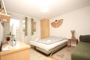 niewielka sypialnia z łóżkiem i oknem w obiekcie Kaya Apartments w Sarajewie
