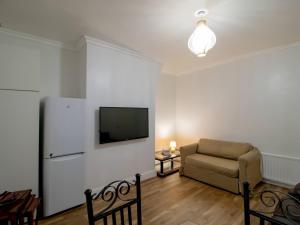 a living room with a couch and a flat screen tv at Pass the Keys Cosy Flat in Newcastle Upon Tyne in Elswick