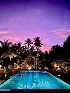 a swimming pool at a resort at night at Mahaloka Valley Nusa Penida in Nusa Penida