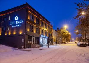 a hotel on a snowy street at night at IŞIL PARK HOTEL in Kars