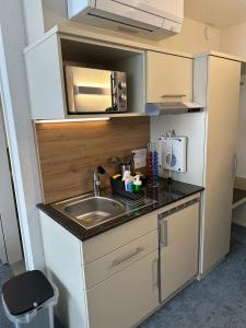 a small kitchen with a sink and a counter at Aparthotel Krone - Self Check-In in Interlaken