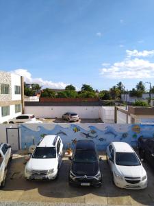 a group of cars parked in a parking lot at Pousada Aruamar in Aracaju