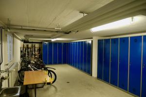 a garage with blue lockers and a group of bikes at CASA BELLINA in Davos