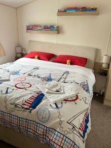 a bed with a bedspread with a plane on it at 6 berth caravan Cherry tree holiday park Great yarmouth in Belton