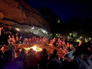 a group of people sitting around a fire at night at Village Light House Dahab in Dahab +9 photos