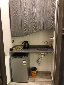 a small kitchen with a sink and a stove at Village Light House Dahab in Dahab