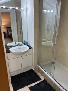 a bathroom with a glass shower and a sink at Ensuite Room w/ private entrance in Royal Victoria Excel O2 Arena London in London