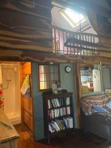 a room with a bunk bed and a book shelf at Games Room in Llanfynydd