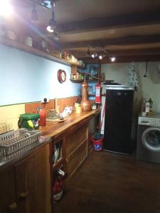 a kitchen with a sink and a washing machine at Games Room in Llanfynydd