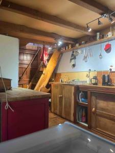 a large kitchen with wooden cabinets and a staircase at Games Room in Llanfynydd