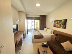 a hotel room with a bed and a couch at Maria s Single Room with Gym and Bar in Jounieh