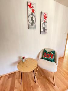 a living room with a chair and a table at Apartment Cristian in Timişoara
