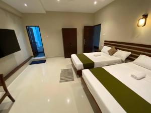 Postel nebo postele na pokoji v ubytování Lamandu City Hotel