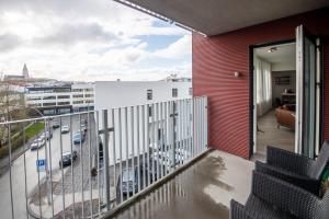 a balcony with a view of a city at Lovely modern 1-bedroom apartment, free parking in Reykjavík