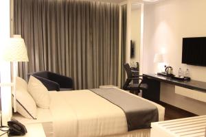 Una cama o camas en una habitación de Grace 21 Smart Hotel