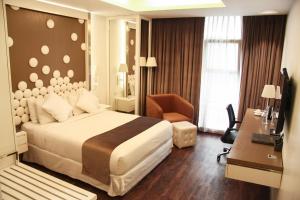 a hotel room with a bed and a desk at Grace 21 Smart Hotel in Dhaka