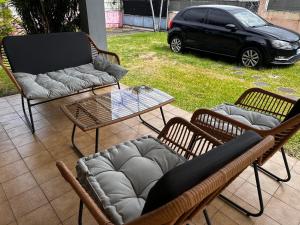 a patio with a couch and chairs and a table at NM-Housing in Saint-Denis