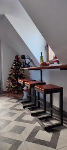 a staircase with a christmas tree and benches in a room at Mountain inn in Žabljak